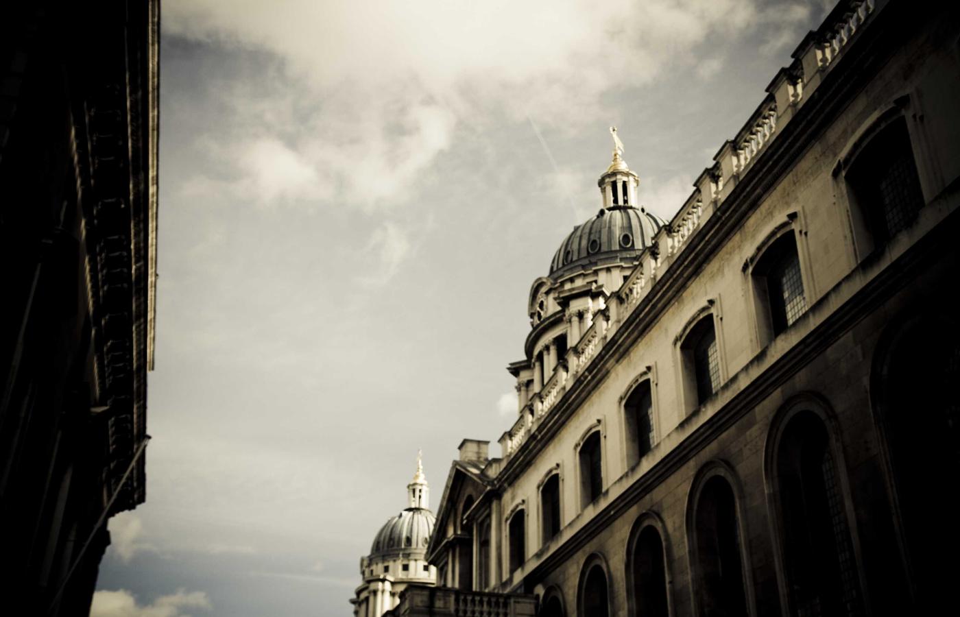 Modern office with developers collaborating around a screen.