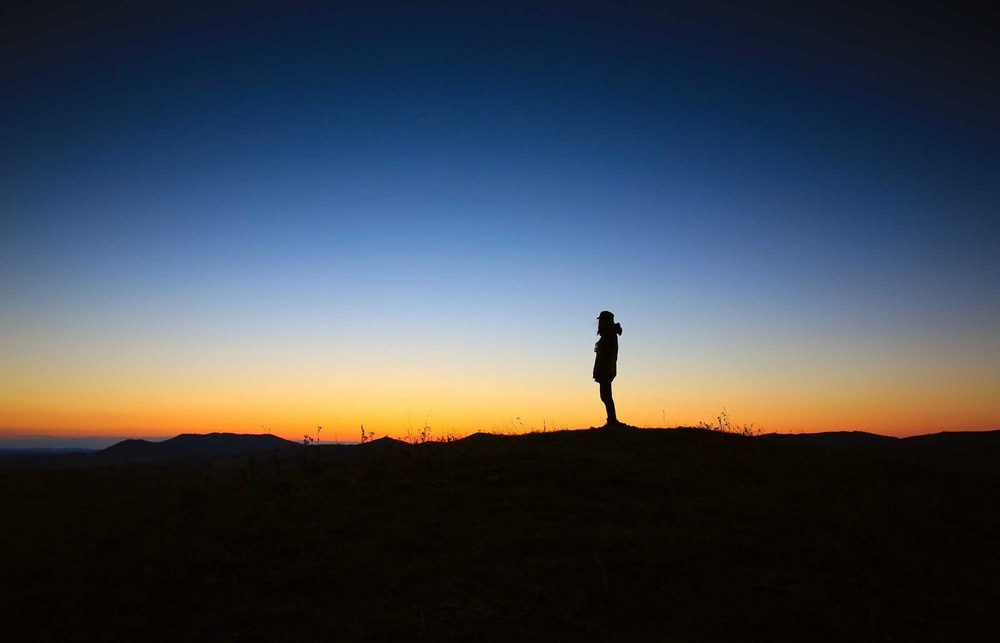 A combine harvester working in a vast grain field in Saskatchewan.